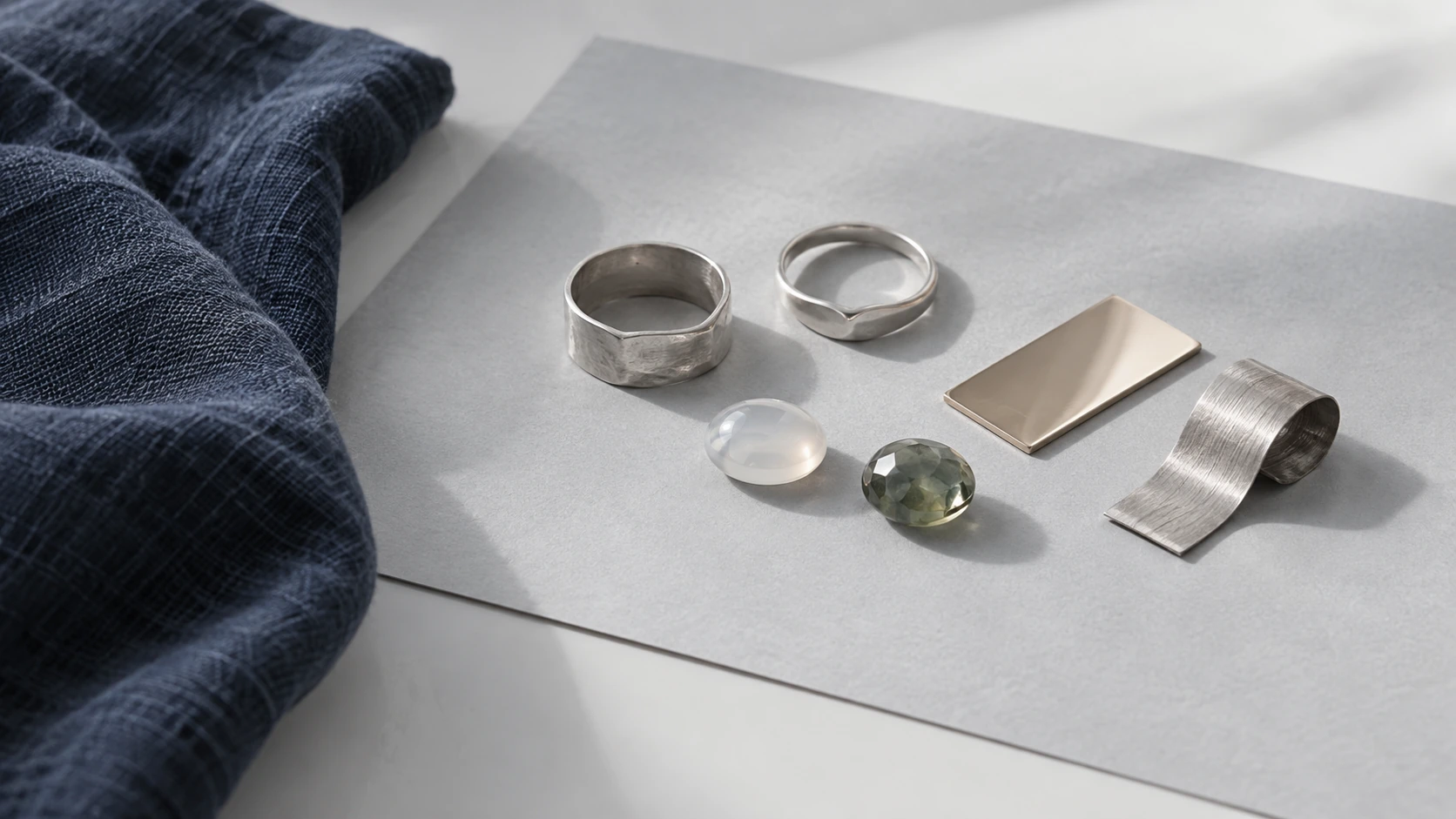 Silver, pale gold and stone material study, photographic concept